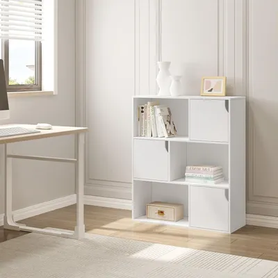 A white modular bookshelf with 6 cubes and doors, placed in a room with a desk and window.