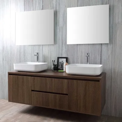 A modern bathroom vanity with two sinks and two mirrors against a wood-paneled wall.