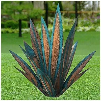 A metal agave plant sculpture sits on a green lawn with trees in the background.