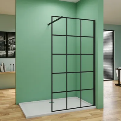 A modern shower enclosure with a black grid design is shown in a bathroom setting with green walls and a wooden floor.