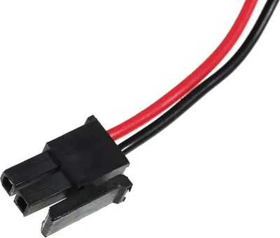 A close-up shot of a black electrical connector with red and black wires.
