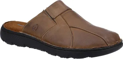 A single brown mule shoe is shown from a diagonal angle against a white background.