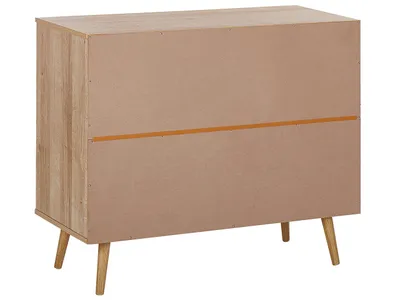 The back view of a wooden dresser with tapered legs.