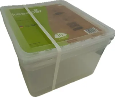 A clear plastic storage box with a green and brown label, secured by a white elastic band.