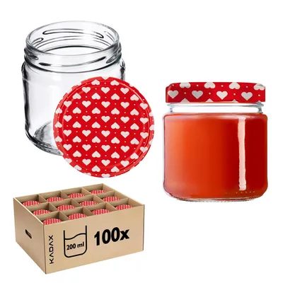 A collection of glass jars with red lids decorated with white hearts, some filled with a red substance, and a cardboard box containing multiple jars.