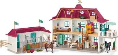 A toy horse stable and house playset with figures.