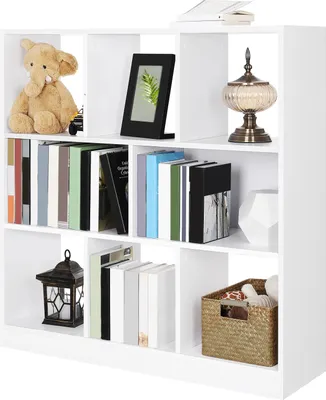 A white cube bookshelf filled with various decorative items and books.