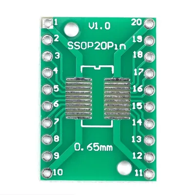 A top-down view of a green circuit board adapter with numbered pins and silver connectors.