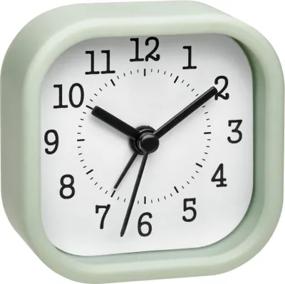 A close-up studio shot of a pastel green alarm clock.
