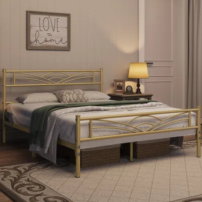 A bedroom scene with a gold metal bed frame as the main focus, decorated with pillows and a blanket. A bedside table with a lamp and framed pictures is visible.