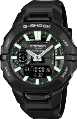 A black Casio G-Shock watch with green accents and a digital display.