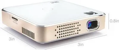 A small, white and gold projector with dimensions indicated.