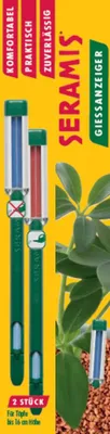 A product shot of two plant watering indicators with green bodies and clear tubes showing blue and red indicators, set against a yellow background with green foliage on the right.