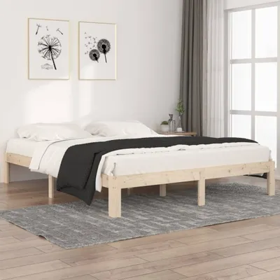 A bedroom scene with a wooden bed frame and bedding.