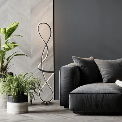 A modern living room with a sofa, plants, and a unique floor lamp.