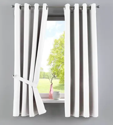 A white curtain is tied back with a white tie-back, revealing a window with trees and sky outside. A pink vase and a grey pot sit on the windowsill.