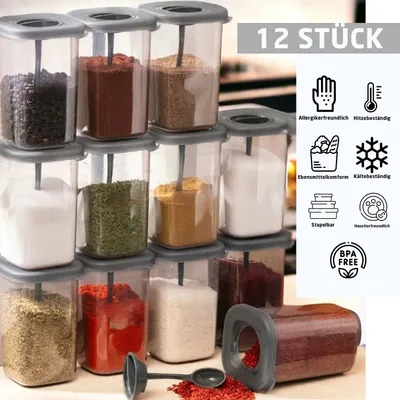 A collection of 12 clear plastic storage containers with anthracite lids, filled with various spices and ingredients, arranged in stacks.