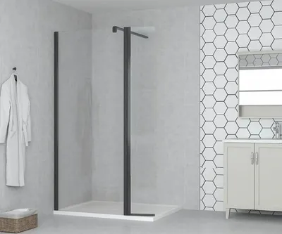 A modern bathroom with a shower enclosure, vanity, and hexagonal tiles.