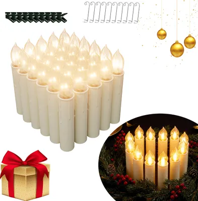 A collection of LED Christmas candles, some arranged in a wreath, with a gift box and decorative ornaments in the background.