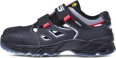 A side view of a black safety sandal with red and white accents.