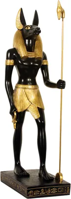A statue of the Egyptian god Anubis standing on a base.