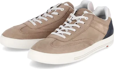 A pair of beige low-top sneakers with white laces and soles, and a navy heel accent.