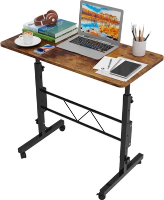 A laptop table with a laptop, books, headphones, and a cup of coffee on it.