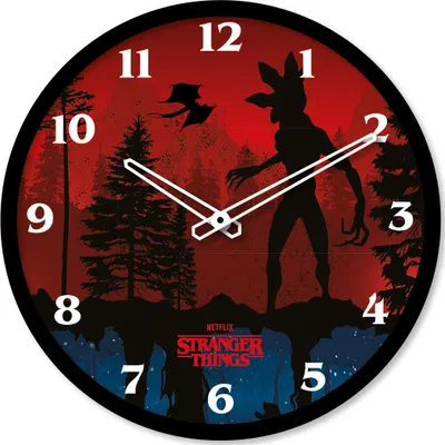 A wall clock with a Stranger Things theme, featuring a silhouette of the Demogorgon against a red, forest-like background.