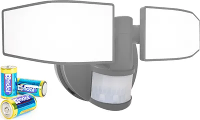 A battery-powered LED floodlight with a motion sensor and two adjustable heads, shown with batteries in the foreground.