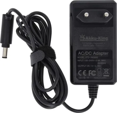 A black AC/DC adapter with a coiled black cable and a power plug.