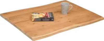 A wooden tabletop with a book and a mug on it, set against a white background.