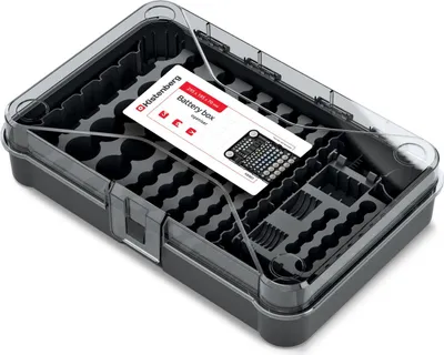 An open battery storage box with various compartments for different battery sizes.