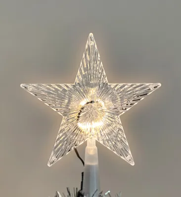 A close-up of a star-shaped Christmas tree topper with integrated LED lights.