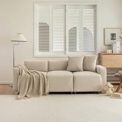 A modern living room setting with a beige sofa, a floor lamp, and a wooden cabinet.