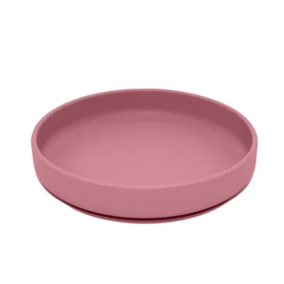 A pink silicone plate with a suction base, shown from a slightly elevated side angle against a white background.