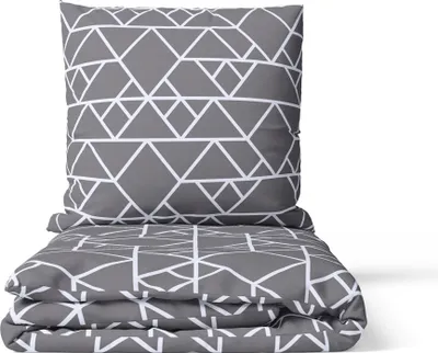 A folded duvet cover and pillowcase set with a geometric pattern.