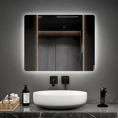 A modern bathroom vanity with a sink, mirror, and accessories.