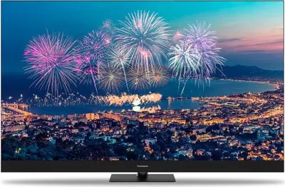A television screen displaying a vibrant fireworks display over a city at night.