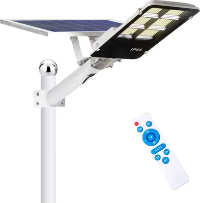A solar street light with a solar panel and a remote control, shown against a white background.