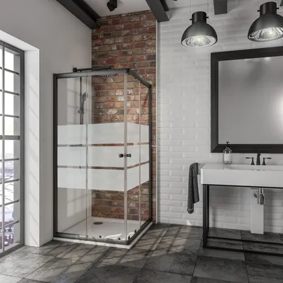 A modern bathroom with a black-framed glass shower enclosure, a white sink with a black faucet, and exposed brick and white subway tile walls.