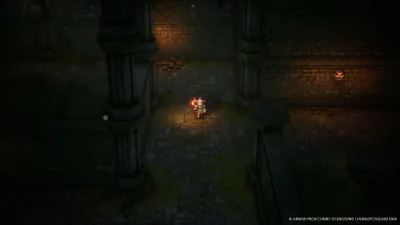 A character in a video game is walking down a dark, stone corridor.
