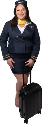 A woman in a stewardess costume stands next to a suitcase.