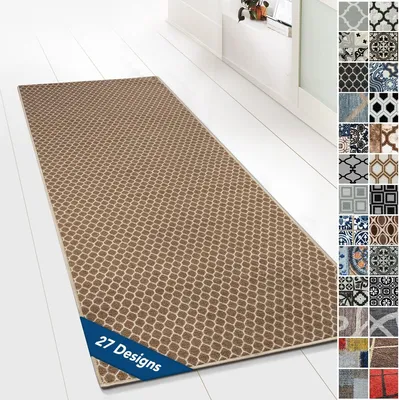 A long runner rug with a geometric pattern is laid out on a white wooden floor in a hallway.