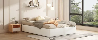 A bedroom scene with a white bed, nightstand, and a large window overlooking trees.