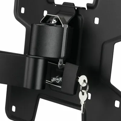 A close-up view of a black metal wall mount bracket with a locking mechanism and keys.
