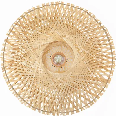 A top-down view of a round, woven bamboo lamp shade with a spiral pattern.