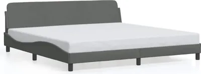 A dark gray fabric bed frame with a white mattress on a white background.
