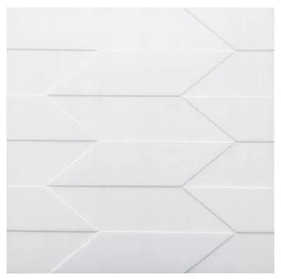 A close-up, full-frame shot of a white 3D wall panel with a geometric chevron pattern.