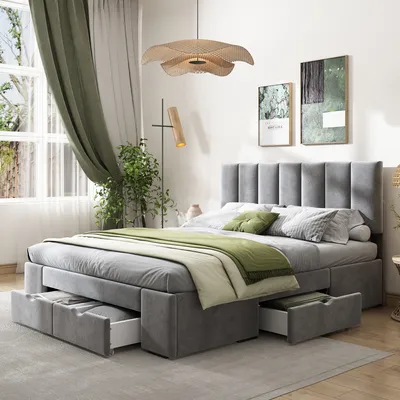 A bedroom scene featuring a grey upholstered bed with storage drawers and green bedding.