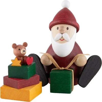 Produktbild von Weihnachtsmann mit Geschenk und Geschenkestapel (8,3cm) von Ullrich Kunsthandwerk